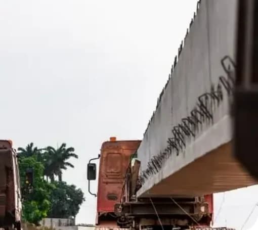Precast concrete beams loaded on trucks for heavy transport